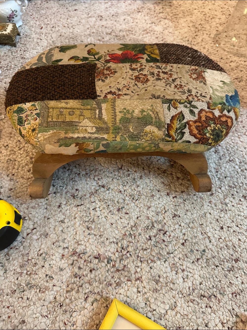 Antique wooden rocking footstool features a charming multicolor floral tapestry